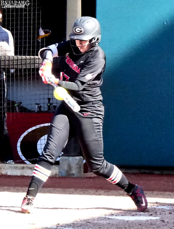The ball jumps off Maeve McGuire's back headed for the right center field fence