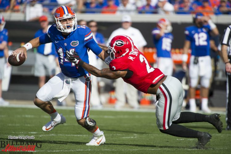 Maurice Smith (2) gets to Florida QB Del Rio (14)