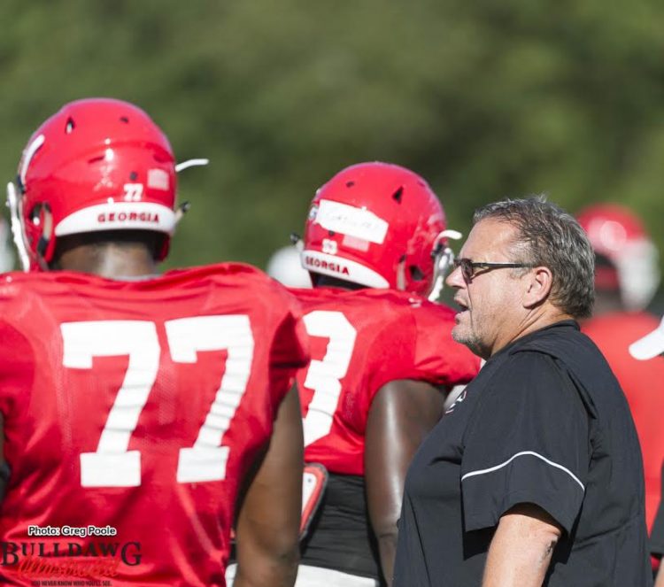 Offensive Line Coach Sam Pittman talking with Isaiah Wynn (77)