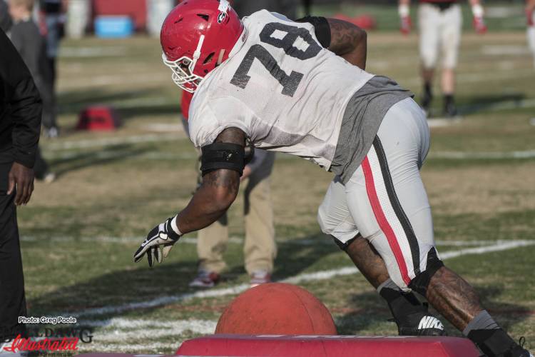 Trent Thompson (78) runs through a cut block drill during Tuesday's practice.