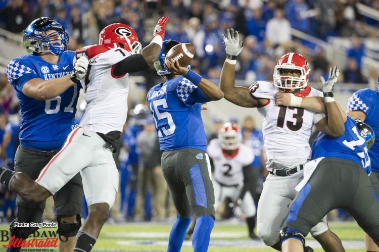 Lorenzo Carter (7) and Jonathan Ledbetter (13) with pressure on UK QB Stephen Johnson (15)