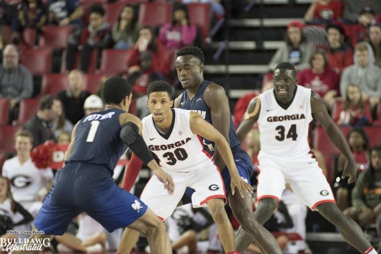 J.J. Frazier (30) and Derrick Ogbeide (34) play defense.