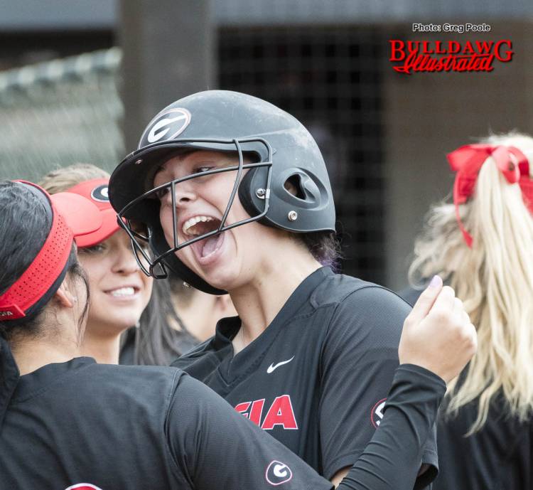 Alyssa DiCarlo celebrates her home run with her teammates at home plate