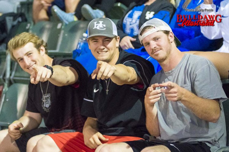 Baseball players Mason Meadows, Tony Locey and Drew Moody take in the Lady Diamond Dawgs' game