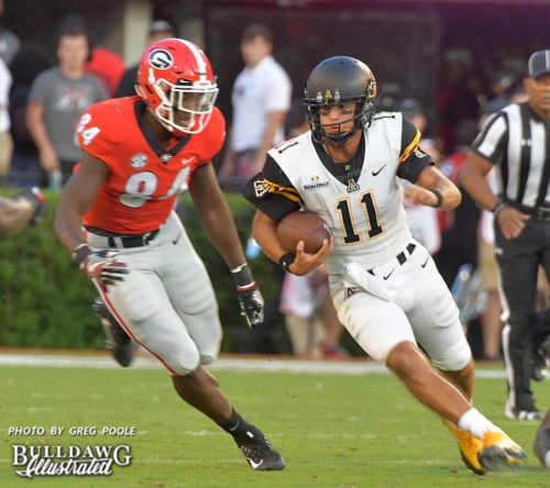 Freshman linebacker Walter Grant (84) zeroes in on Mountaineer QB Taylor Lamb (11)