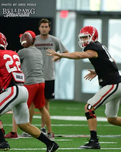 Jacob Eason tosses the ball to No. 22 (not Nate McBride)