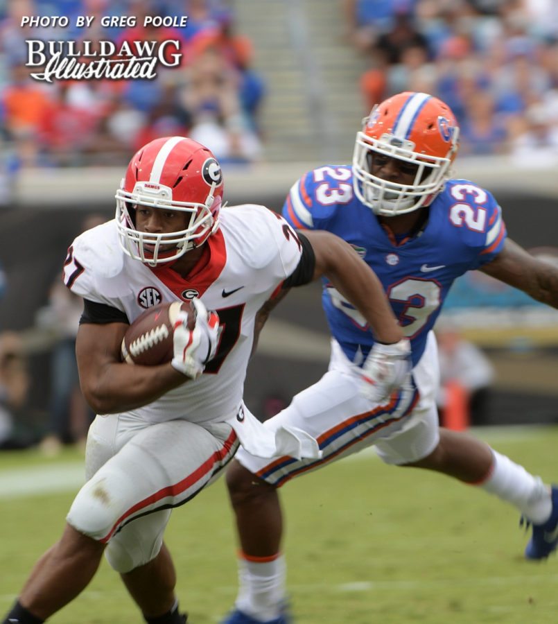 Florida's Chauncey Gardner (23) gives chase to Georgia's Nick Chubb (27)