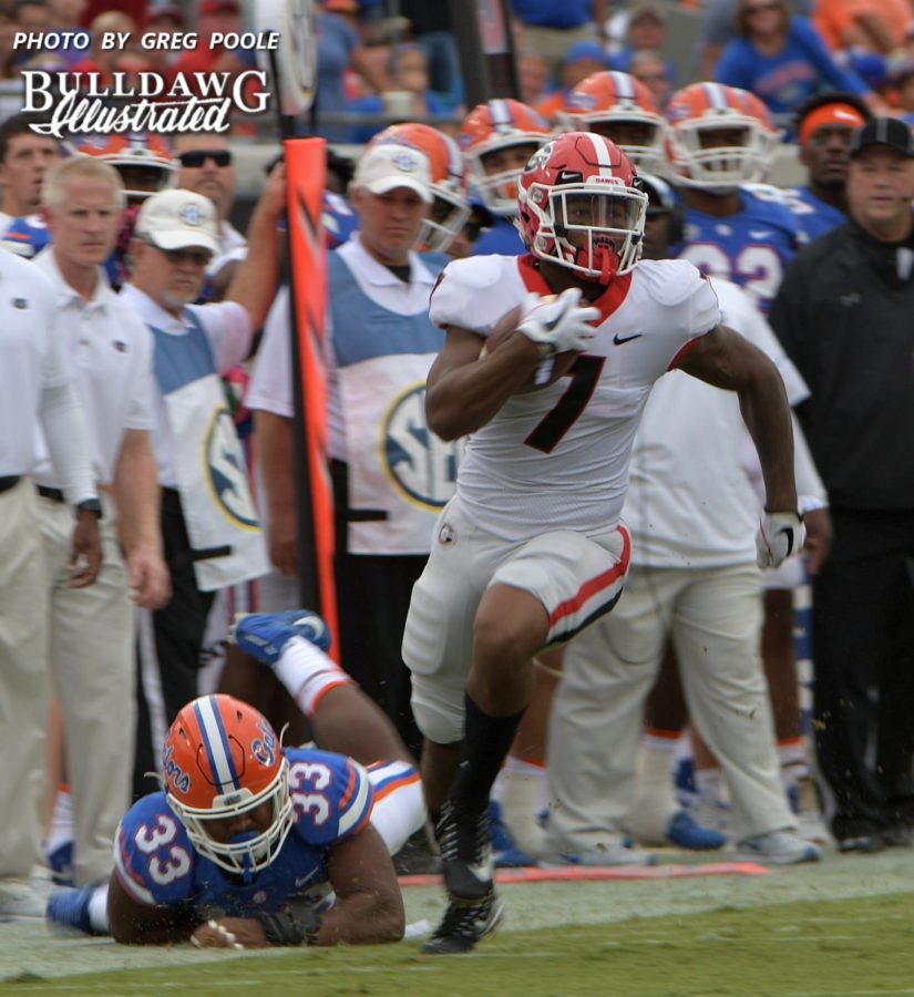 Bulldog freshman tailback D'Andre Swift (7) takes a Jake Fromm pass 39-yards down to the Gator 6-yard line for a 1st down and goal in the first quarter of Saturday's Georgia-Florida game.