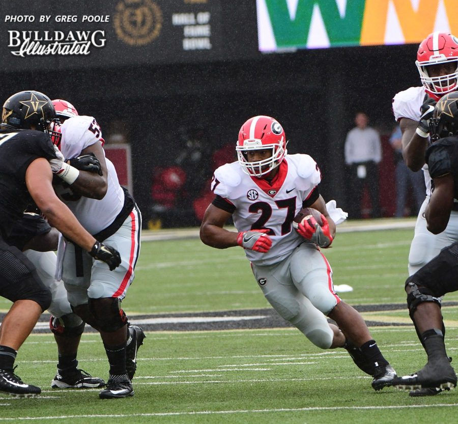 The Georgia O-line opens up a big hole for running back Nick Chubb (27) - First half of UGA vs. Vanderbilt - Saturday, October 7, 2017