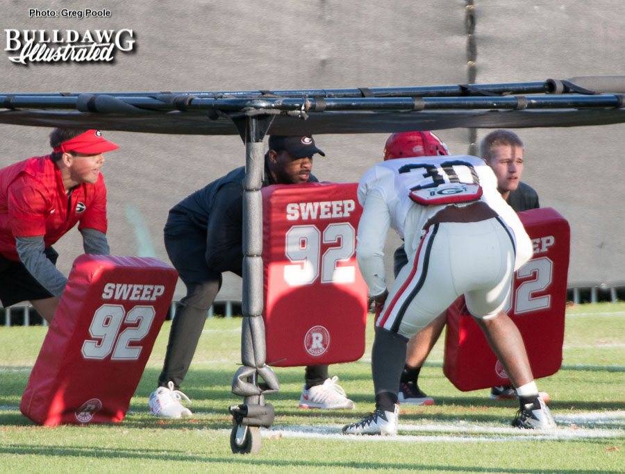 Linebacker Tae Crowder works under the chute during Tuesday's afternoon practice.